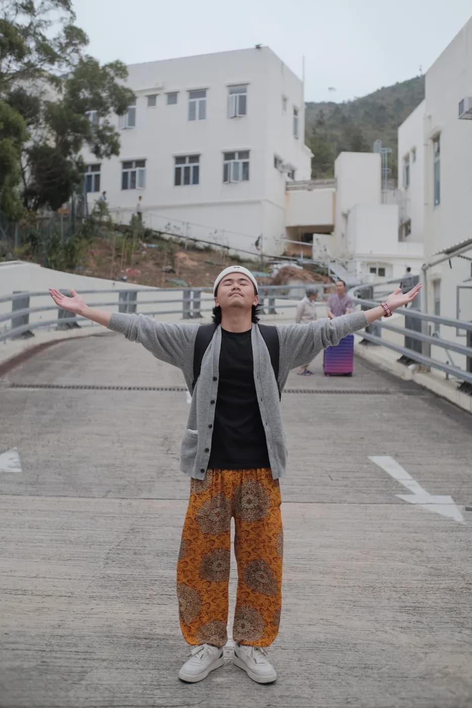 Arms outstretched outside a Vipassana meditation center